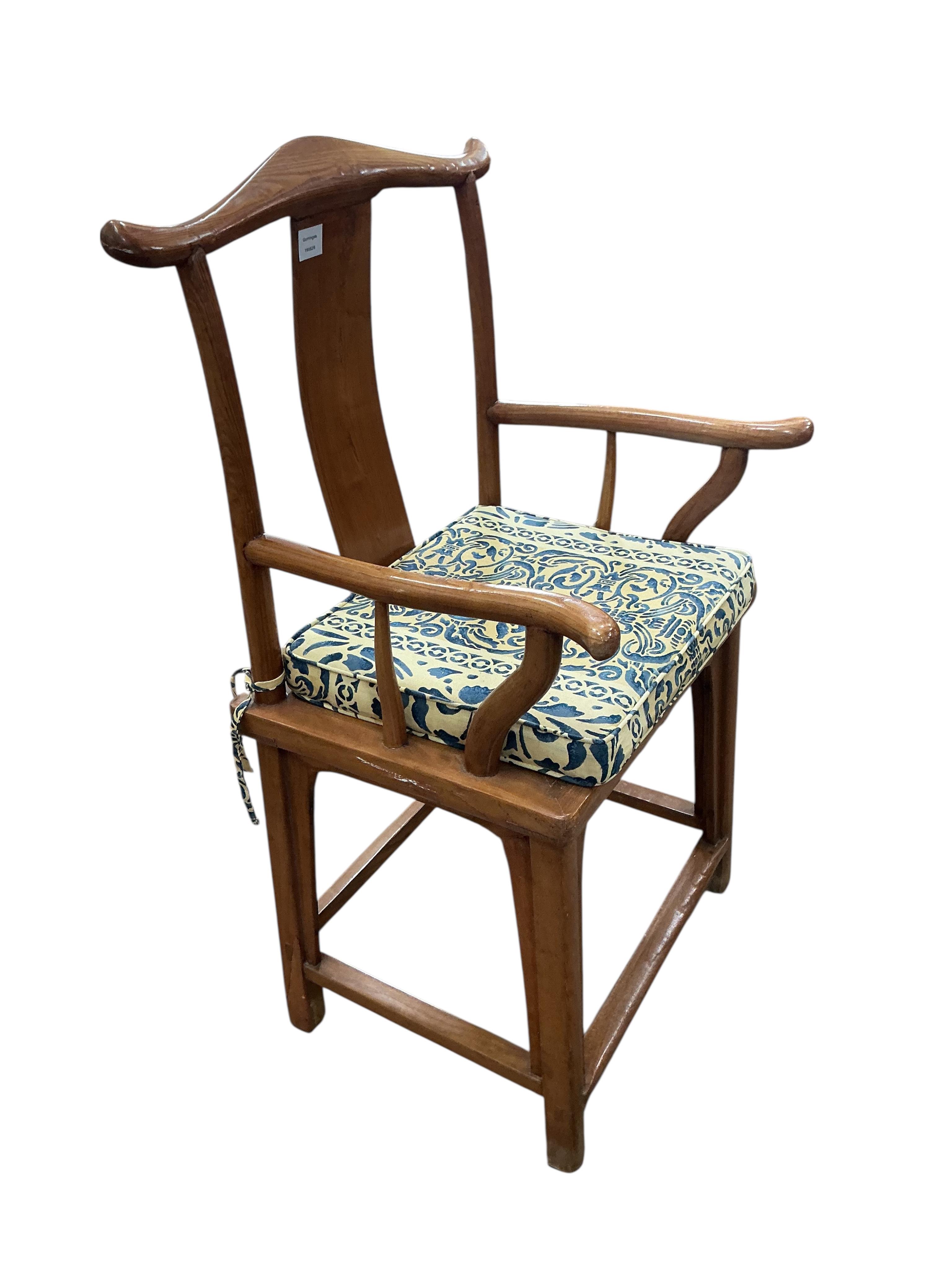 A Chinese elm elbow chair, width 58cm, depth 46cm, height 110cm